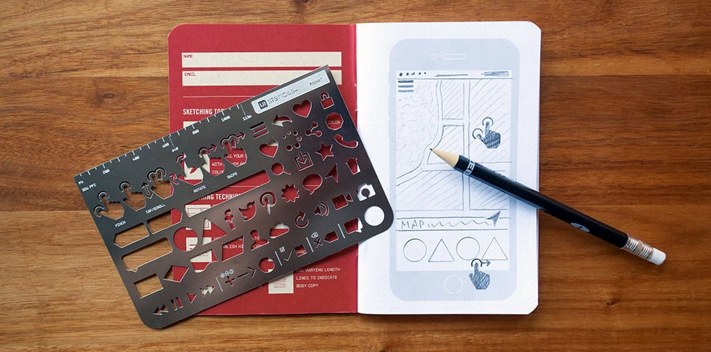 Everyday Carry Kit in action: a mobile app UI sketched out on the notebook using the included stencil and pencil.