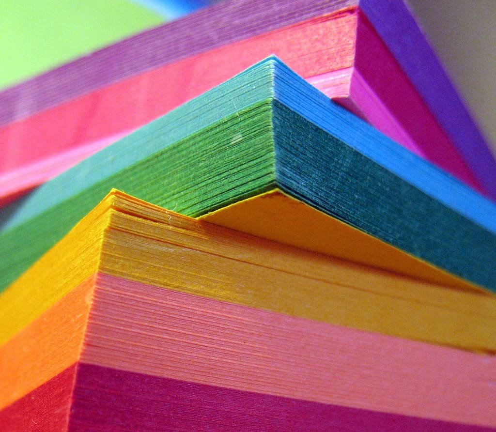 Image of a pile of sticky notes in all different colors.