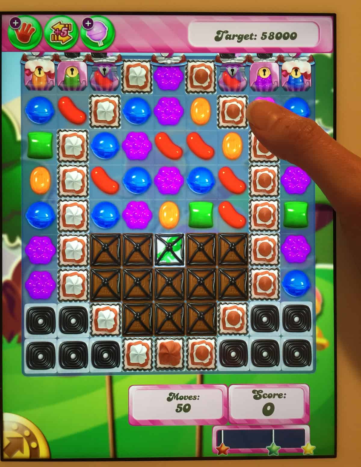 A photo of a person playing Candy Crush.