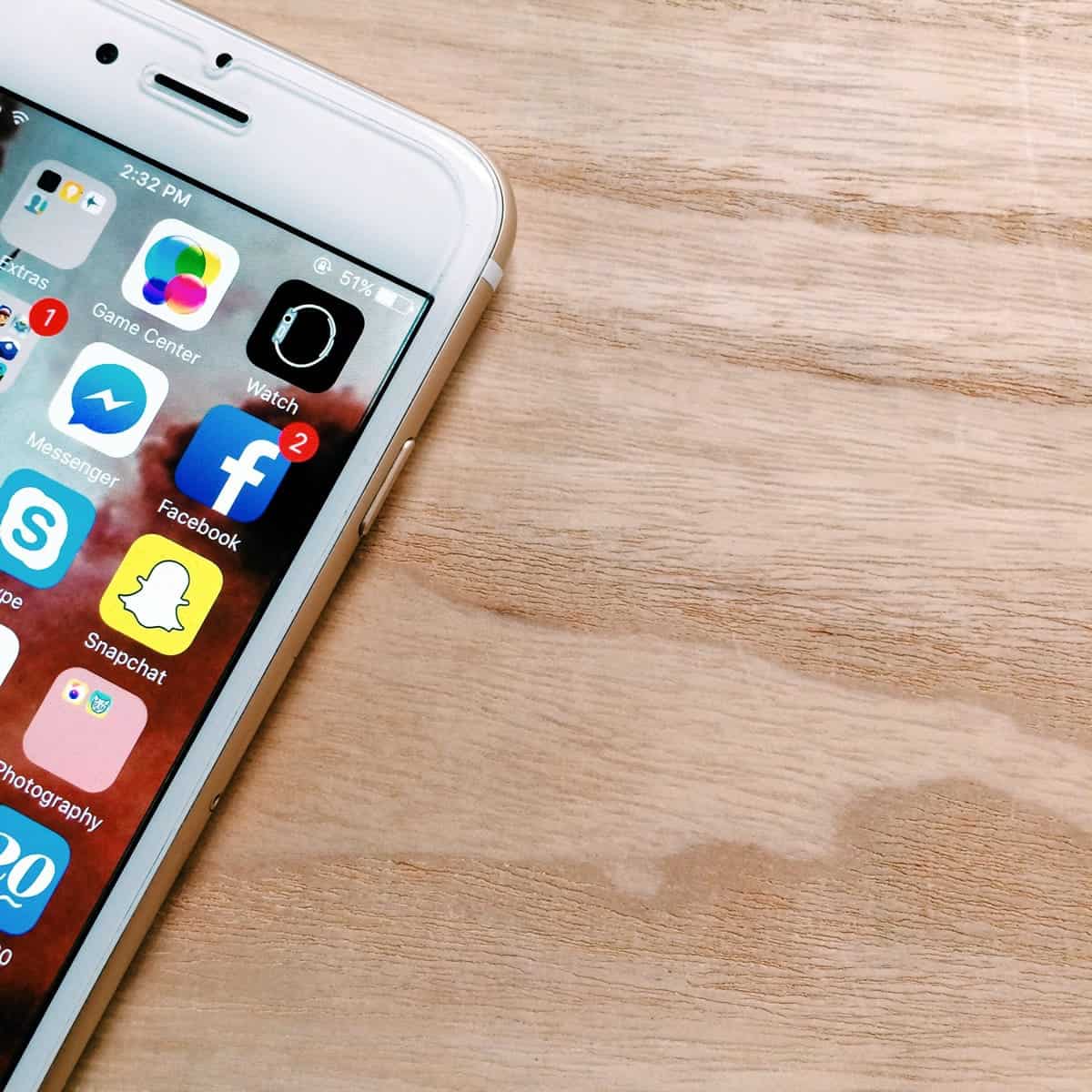 Uma foto de um iPhone branco deitado sobre uma mesa.